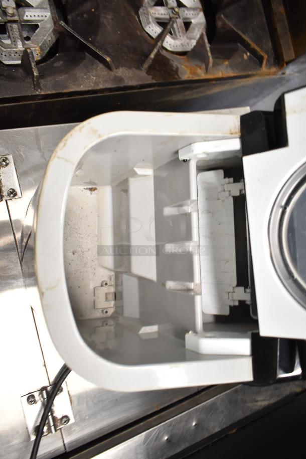 Frigidaire EFIC117-SSBLACK countertop ice machine's interior, showing ice compartment and light wear.