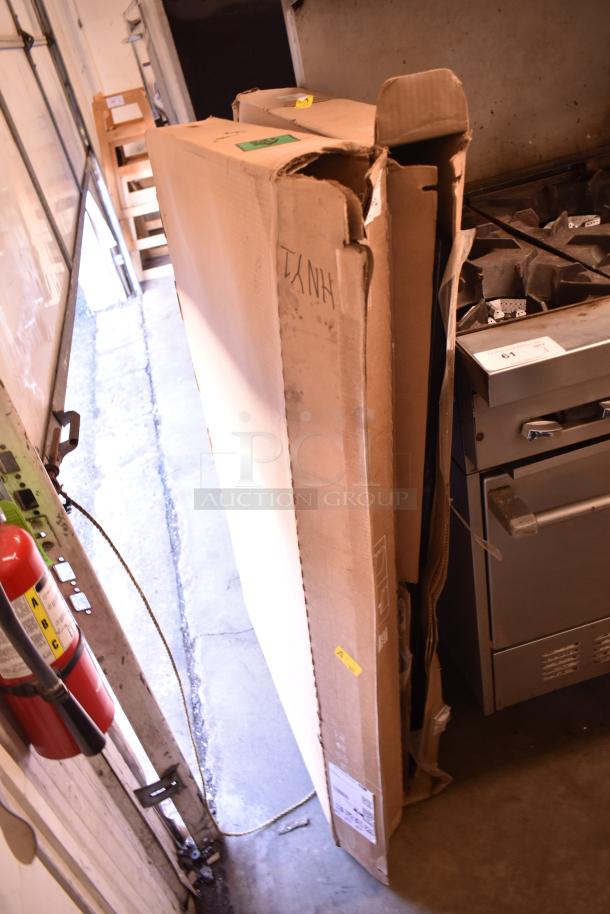 Two Samsung 50" Smart Signage LED displays in partially opened cardboard boxes, stacking offer, visible labels.