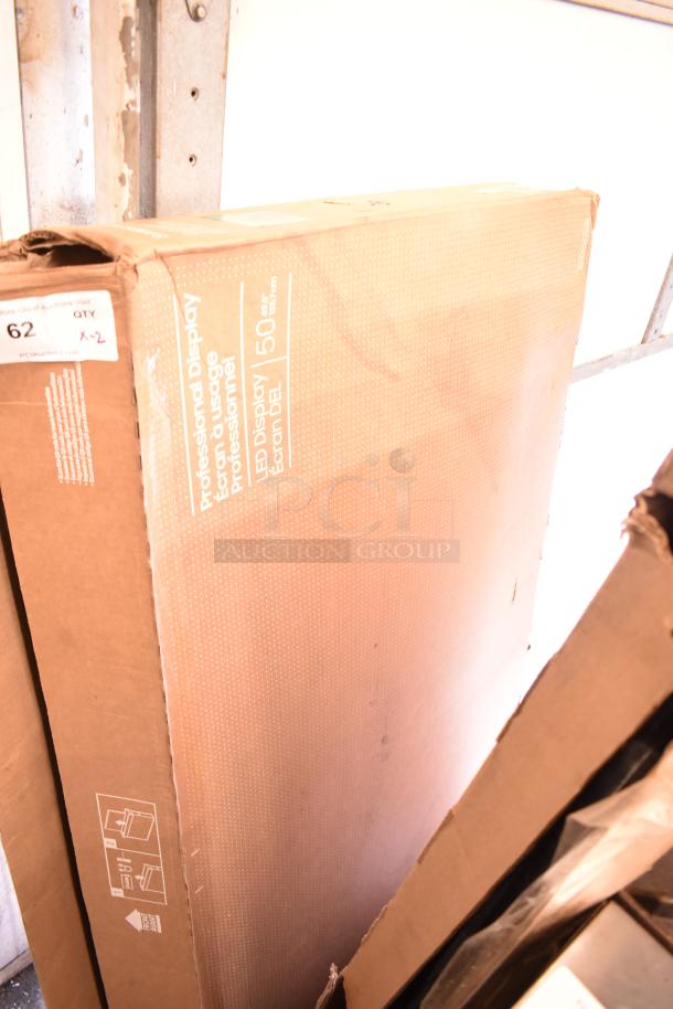 Two Samsung 50" Smart Signage LED Displays in packaging, model and condition unspecified. Auction lot labeled "62".