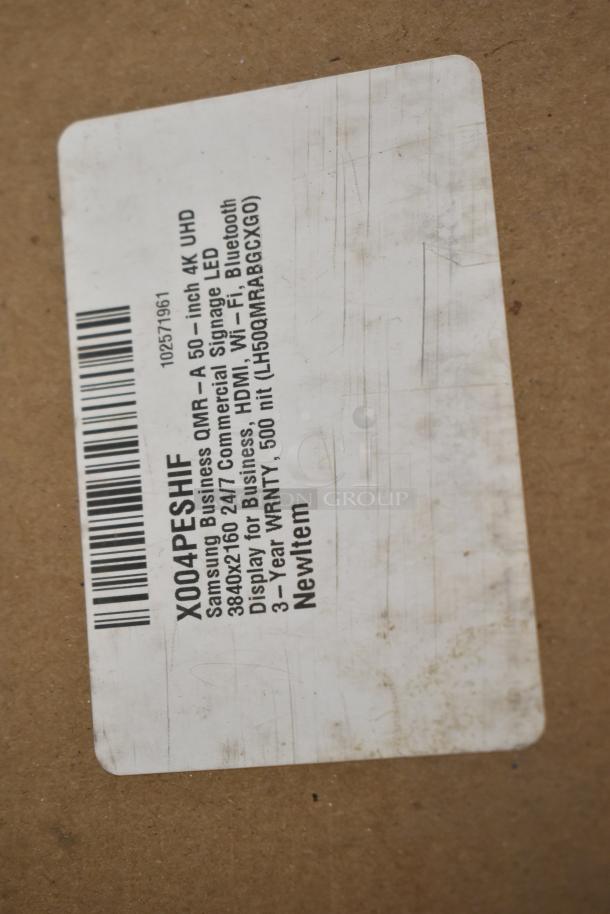 Label on packaging showing Samsung Business QMR-A 50" 4K UHD Commercial Signage LED Display. New item with 3-year warranty.
