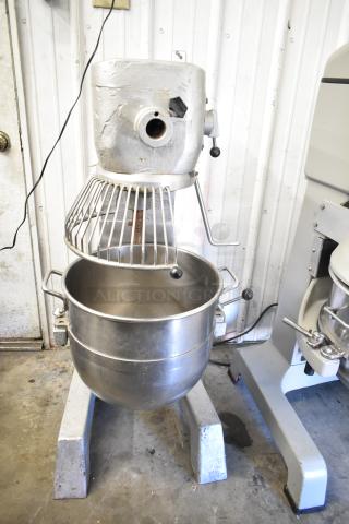 Commercial planetary dough mixer with bowl and guard, floor style, stainless steel, used condition, visible wear.