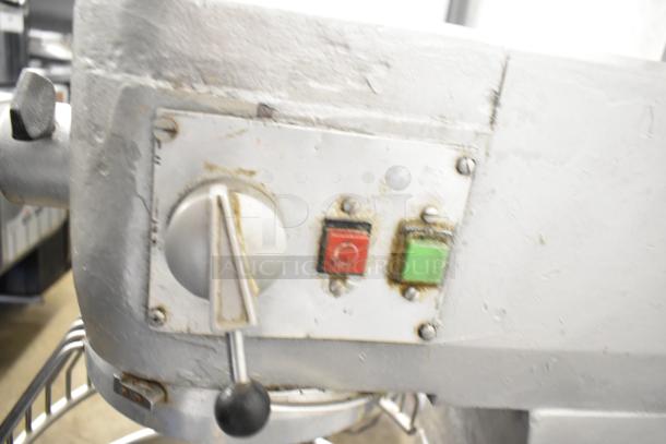 Commercial planetary dough mixer with mixing bowl and bowl guard, featuring control knobs and buttons. Used condition.