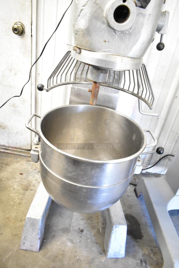 Commercial planetary dough mixer with stainless mixing bowl and bowl guard, floor style, used condition.