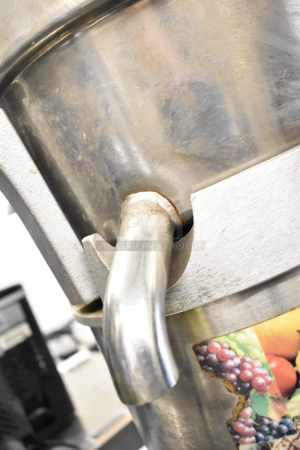 Santos Commercial Countertop Juicer, stainless steel spout, 115 volts, 1 phase, used condition, visible fruit label.