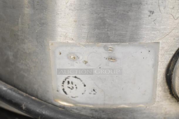 Santos Commercial Countertop Juicer, 115 volts, 1 phase. Features stainless steel body with visible wear and a partially obscured label.