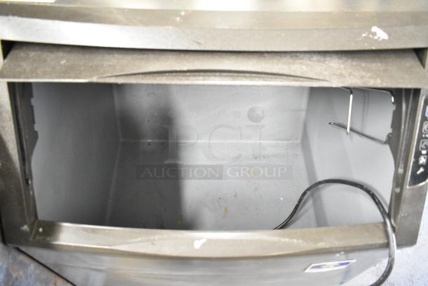 2018 Manitowoc UYF0140A ice maker with bin, cube-style, 100-200 lbs/day, 115V, 1 phase, open bin view, good condition.