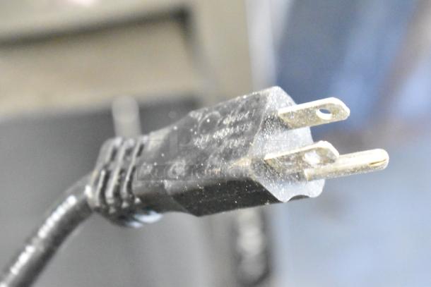 Close-up of the power plug for a Manitowoc UYF0140A ice maker. The plug appears slightly dusty.