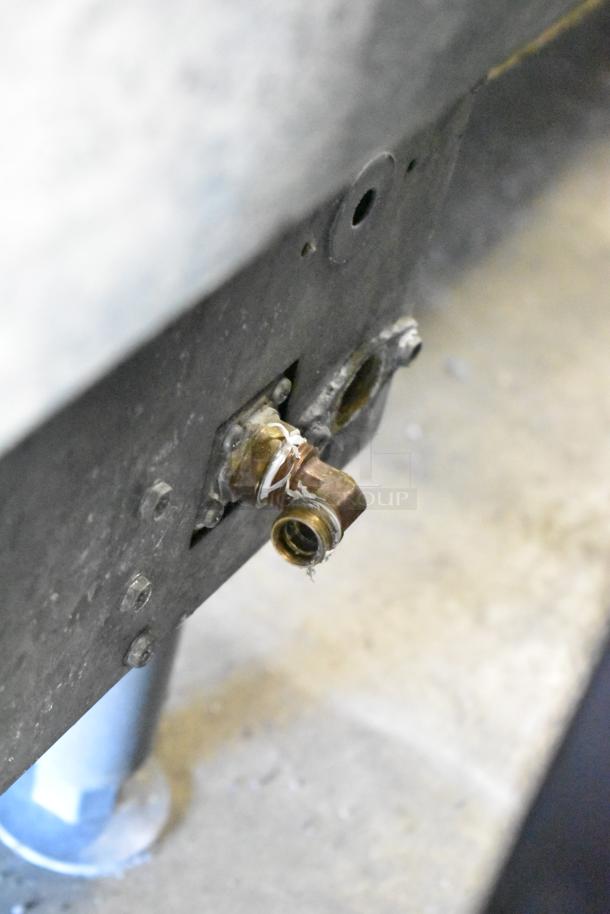 Close-up of a connection fitting on a 2018 Manitowoc UYF0140A Half-Dice Ice Maker. Visible wear and sealing material.