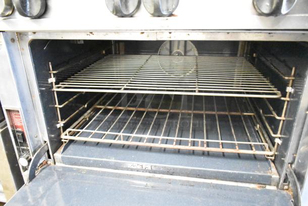 Southbend P32A-BBB commercial range with 6 burners, convection oven, salamander cheese melter, and backsplash.