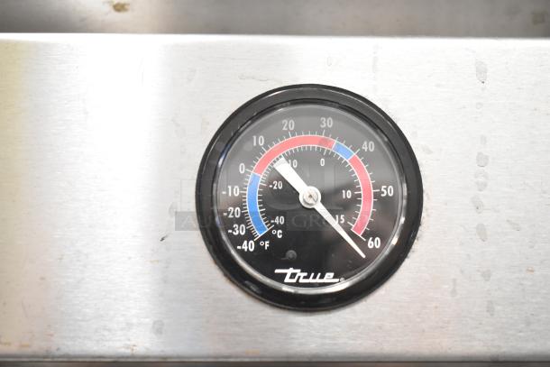 True T-49F freezer temperature gauge displaying Fahrenheit and Celsius on stainless steel surface.