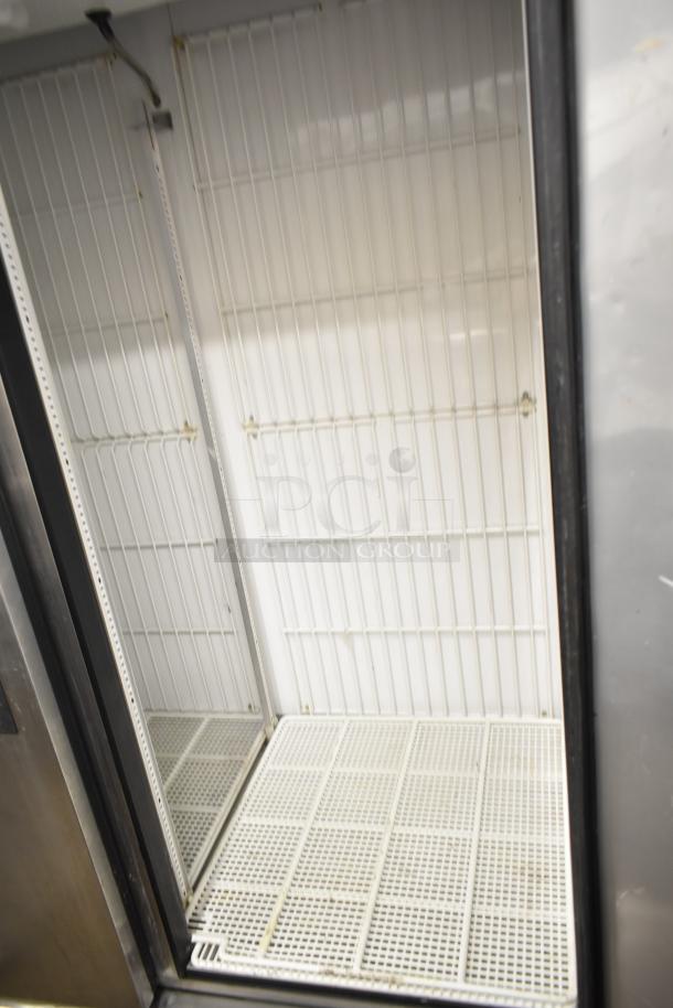 True T-49F Commercial Freezer, 2-door, clean interior, wire shelving, 115V, 1 Phase. Auction item, ideal for businesses.