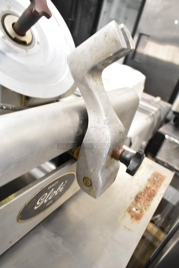 Globe 500 commercial meat slicer, missing carriage, with blade sharpener, 115 volts, 1 phase, visible wear.