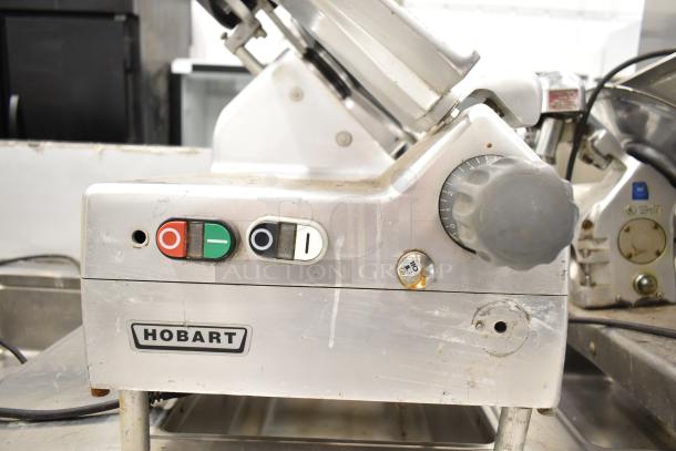 2019 Hobart Edge13A-11 meat slicer, missing carriage/arm, with blade sharpener, 115V, 1-phase. Button controls visible.