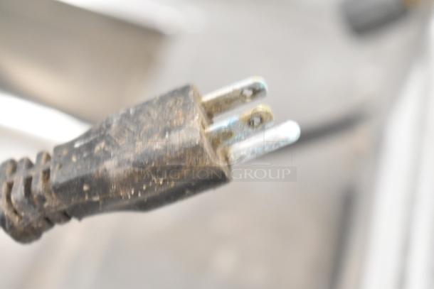 Close-up of a power plug for the 2019 Hobart Edge13A-11 meat slicer. Features a 115V, 1-phase connection. Missing carriage and arm.