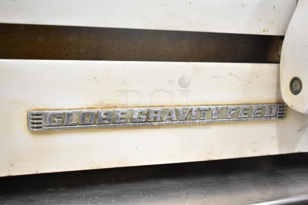 Globe 260 Commercial Meat Slicer with blade sharpener, gravity feed, visible label, used condition, 115V, 1 Phase.