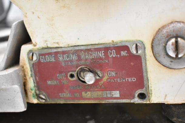 Globe 260 commercial meat slicer with blade sharpener, 115 volts, shown with model and serial number plate.