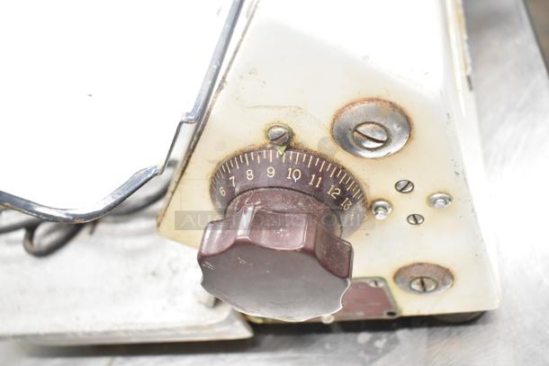 Globe 260 commercial meat slicer with adjustable knob, visible wear, and blade sharpener, 115V, 1-phase, countertop model.