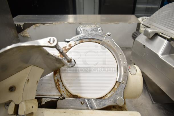 Globe 260 Commercial Meat Slicer with blade sharpener, visible wear, 115 volts, single phase.