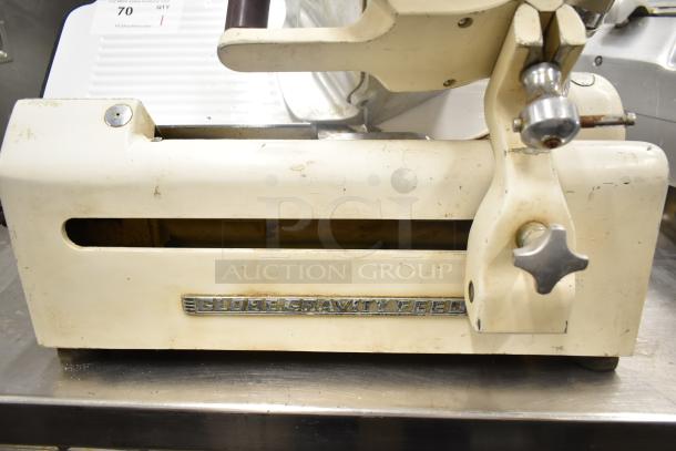 Globe 260 commercial meat slicer with blade sharpener, 115 volts, visible wear, "Globe Gravity Feed" label on side.