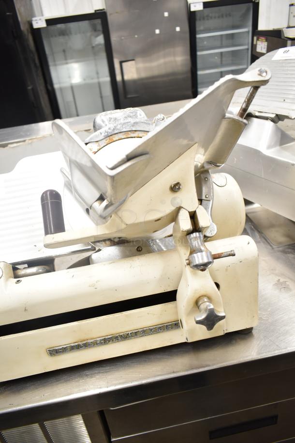 Globe 260 commercial meat slicer with blade sharpener. 115V, 1 phase. Used condition, visible controls and "Globe Gravity Feed" logo.