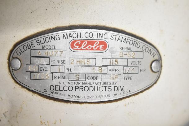Globe 260 Commercial Meat Slicer plate, showing model, serial number B-62, 115 volts, manufactured by Delco.