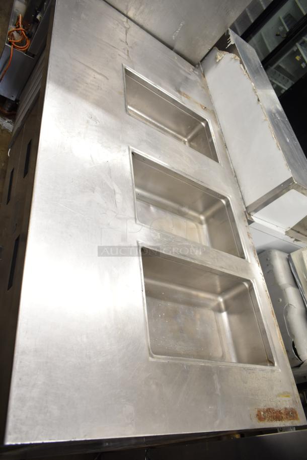 Commercial prep station with three wells, two drawers, and one door. Stainless steel, 115 volts, 1 phase. Used condition.