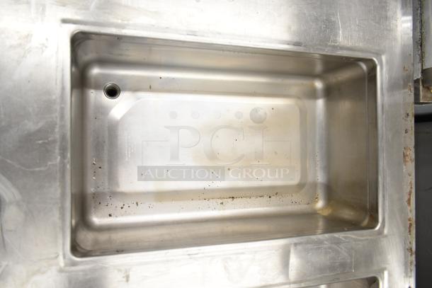 Commercial prep station featuring 3 wells shown, stainless steel, visible wear, suitable for 115 volts, 1 phase power.