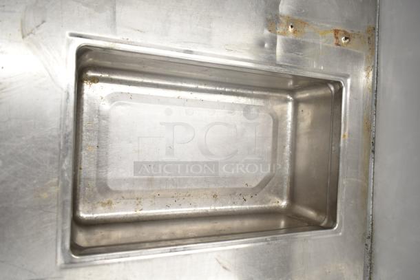 Commercial prep station with 3 wells, 2 drawers, and 1 door, 115 volts, 1 phase. Stainless steel, minor wear visible.