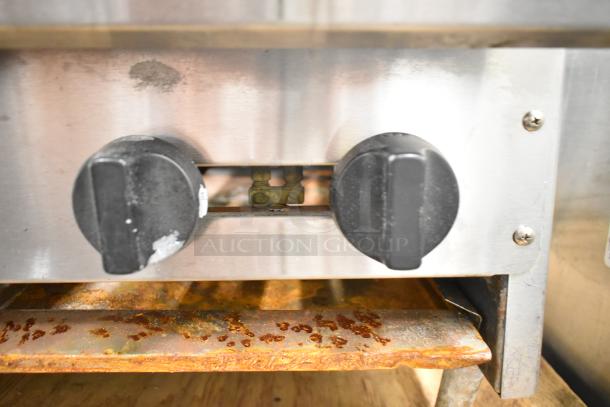 American Range commercial countertop gas 6-burner range, stainless steel, visible wear on control knobs, rust on drip tray.