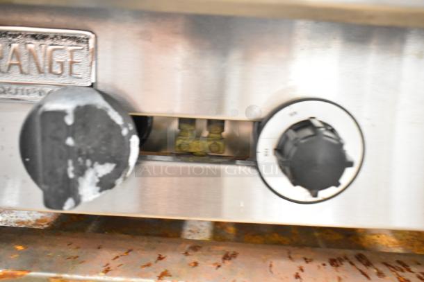 American Range commercial gas 6 burner range, stainless steel, worn control knobs, visible logo plate, countertop model.