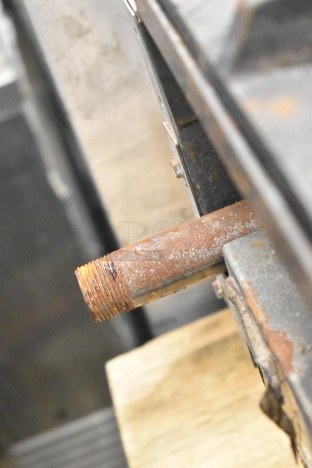 American Range commercial 6-burner gas range in used condition; visible rust and wear on connectors and frame.