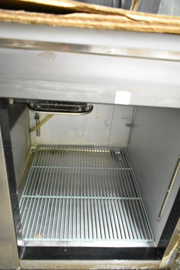 2017 Leader LM48S/C 2 Door Work Top Cooler, 115V, used, showing interior wire shelf and condenser coil.