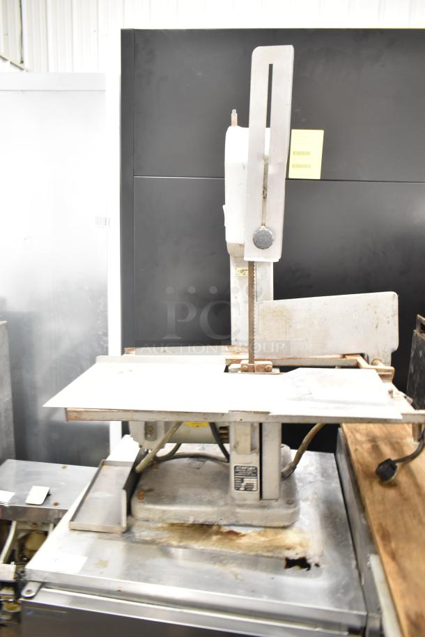 Globe 79 Commercial Countertop Meat Saw, 115 Volts, 1 Phase. Metal surface, visible wear. Model plate attached.