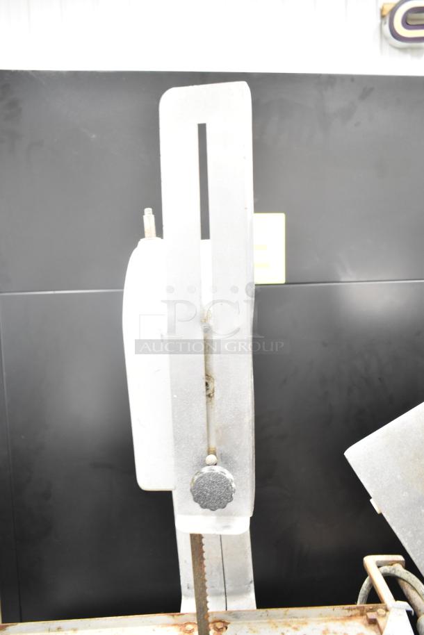 Globe 79 Commercial Countertop Beat Saw, 115V, 1 Phase. Features a durable metal frame with vertical cutting blade.