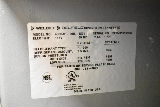 2022 Delfield 406CAP-DHL-DD1 undercounter cooler label showing model, 115V electric requirements, refrigerant details.