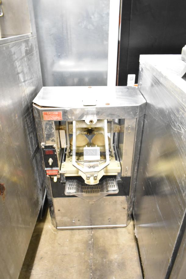 Automatic S-16 commercial citrus juicer, countertop model. 115 volts, 1 phase. Stainless steel exterior with visible operational components.