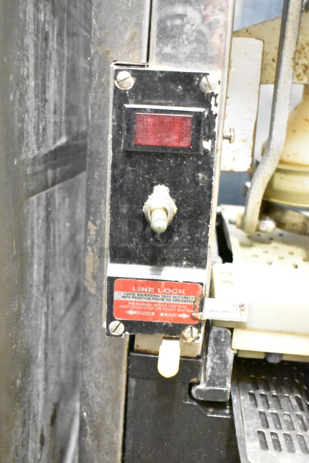 Automatic S-16 Commercial Citrus Juicer with visible line lock switch and instructions, 115 volts, shows signs of use.