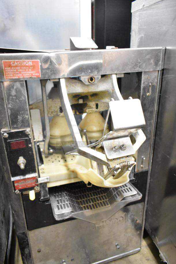 Automatic S-16 commercial countertop citrus juicer, 115 volts, 1 phase. Visible caution label; minor wear visible.