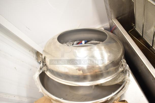 Aluminum domed pizza pan with lock clasp, stackable. Light wear, suitable for commercial kitchen use.