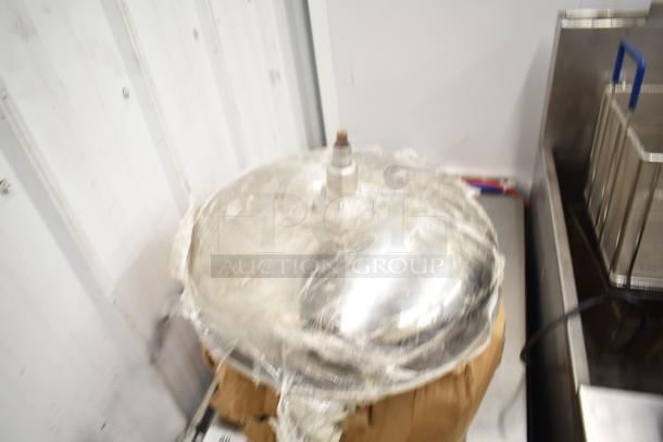 Nine assorted items including metal pizza pans and a wrapped metal component. Items in used condition for auction.