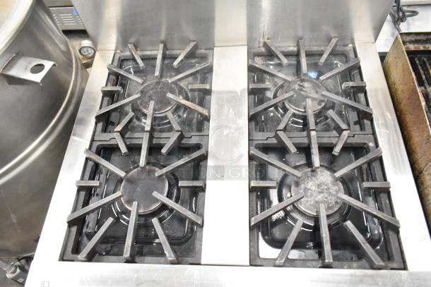 Thermador Professional 4-burner gas range with convection oven, sturdy cast iron grates, stainless steel finish, used condition.