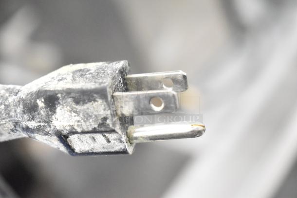 Alt text: Close-up of a worn electrical plug with visible dust and dirt, belonging to a Thermador Professional Range.