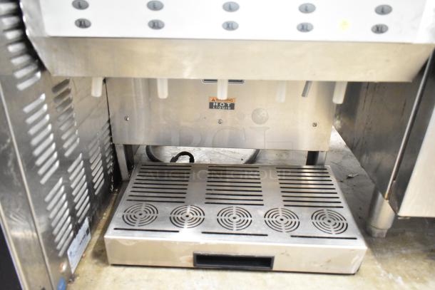 Bunn IMIX-5 Commercial Cappuccino Machine, countertop model. Features a stainless steel drip tray and multiple size options. Visible "Hot Liquid" warning label.