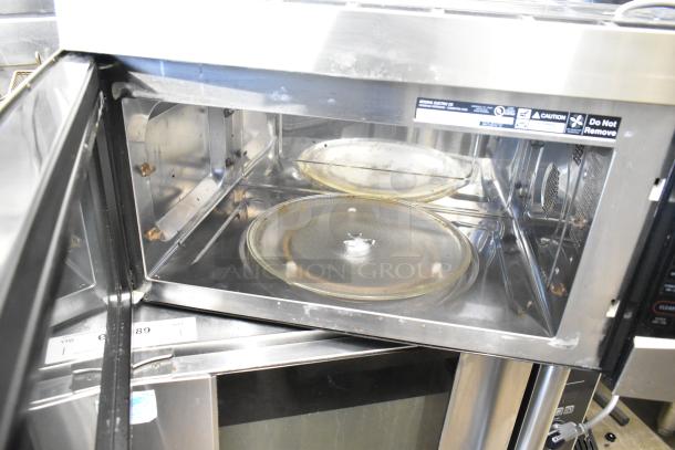 General Electric GE Profile PVM1790SR1SS Microwave with plate, stainless interior, 115V, 1 phase, with visible safety and model labels.