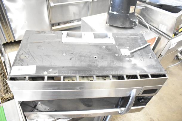 General Electric GE Profile PVM1790SR1SS microwave oven with plate, 115 volts, 1 phase, used condition, visible signs of wear.