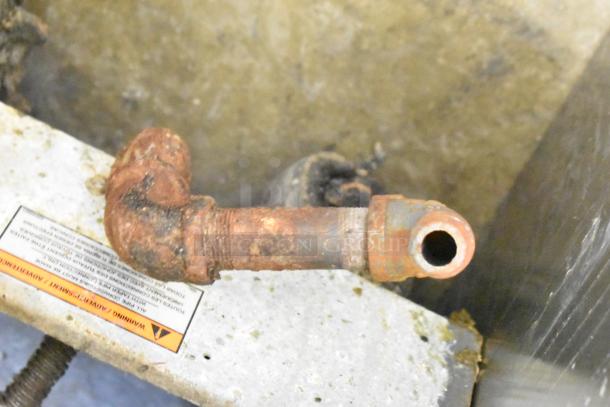 Rusty pipe component on a Pitco Frialator 40C fryer. Condition suggests wear. Warning label partially visible.