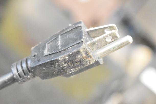 Close-up of a dusty electrical plug for Avanti WC3200BG Mini Cooler Merchandiser, 115 volts, 1 phase.