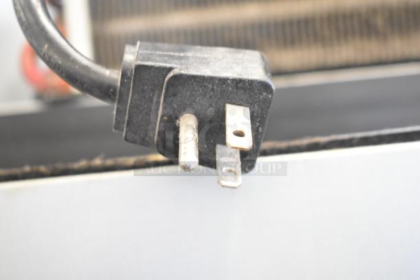 Close-up of a power plug attached to the Everest ESF1 Commercial Single Door Reach In Freezer, 115 Volts, 1 Phase.