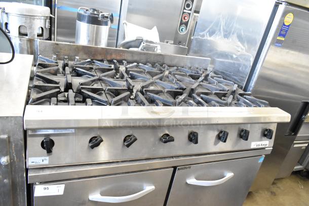 US Range Commercial countertop gas-powered 8-burner range, stainless steel, used condition, visible control knobs, US Range logo.