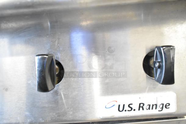 US Range 8 burner gas countertop range. Features control knobs, stainless steel finish, and branding label.